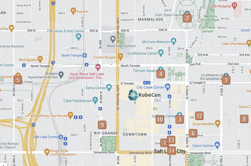 The image is a detailed map of downtown Salt Lake City, highlighting key landmarks, restaurants, hotels, and event centers, particularly around the area for KubeCon 2024. The KubeCon location is marked prominently near the center of the map, surrounded by notable places such as the Utah State Capitol, Temple Square, and various dining and lodging options. Numbered points of interest, such as hotels, eateries, and coffee shops, are clearly indicated throughout the map. Roads and streets are labeled, showing easy access routes around the city and the main event venue.